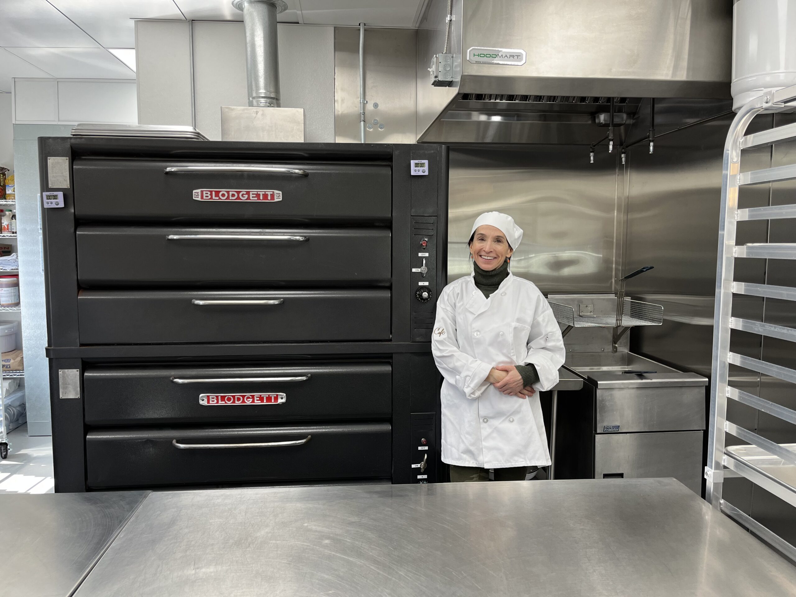 Chef standing in front of kitchen ovens