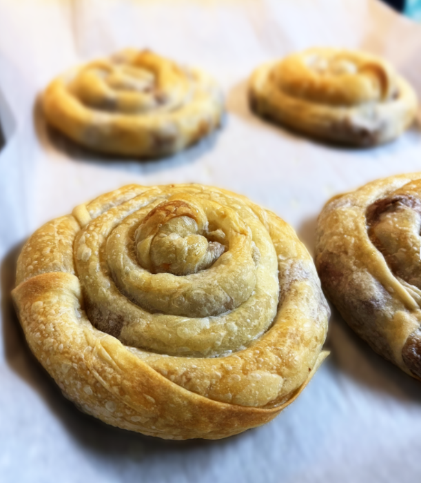Rolled pastries on pan